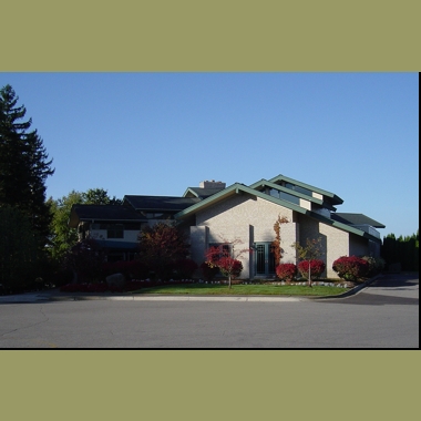 The green accents of the clubhouse play against the reds in the landscaping